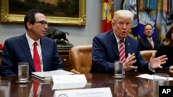 Treasury Secretary Steve Mnuchin listens as President Donald Trump speaks during a meeting on tax policy with business leaders in the Roosevelt Room of the White House, Tuesday, Oct. 31, 2017, in Washington. 