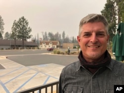 Paradise Town Council candidate Steve Oehler stands in the parking lot of a Starbucks in Paradise, Calif., Sept. 10, 2020. Oehler lost his home in a 2018 wildfire that destroyed most of the buildings in the town. But he has since rebuilt.