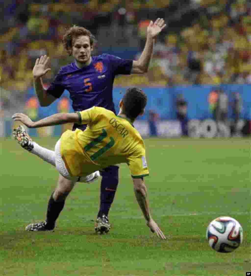 Brazil's Oscar, front, collides with Netherlands' Daley Blind during the World Cup third-place soccer match between Brazil and the Netherlands at the Estadio Nacional in Brasilia, Brazil, Saturday, July 12, 2014. Oscar was booked by the referee for diving
