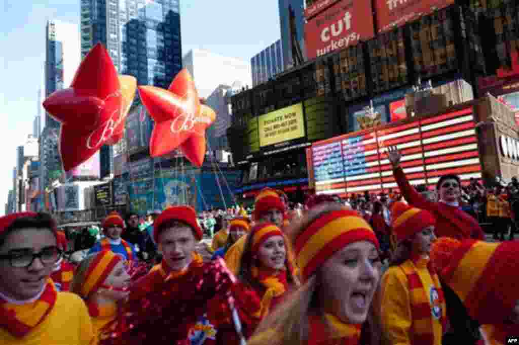 Santa Claus's entourage marches through Times Square during the Macy's Thanksgiving Day Parade, Thursday, Nov. 24, 2011, in New York. A jetpack-wearing monkey and a freakish creation from filmmaker Tim Burton are two of the big new balloons that will make