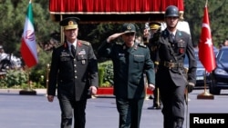 Turkish Chief of Staff General Hulusi Akar and his Iranian counterpart Major General Mohammad Baqeri review the guards of honor during a welcoming ceremony in Ankara, Turkey, Aug. 15, 2017. 