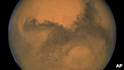 FILE - This Aug. 26, 2003, image made available by NASA shows Mars. Researchers in Australia have developed a new type of space communication that will allow high-definition video be sent from Mars.