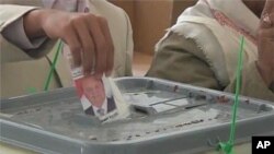 Casting a ballot in Yemen.