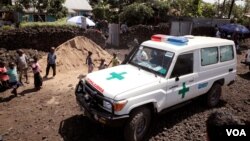 FILE - An ambulance waits next to a clinic to transport a suspected Ebola patient, in Goma, Democratic Republic of the Congo, Aug. 5, 2019.