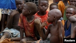 FILE - Orphans and children separated from their parents in Kadugli gather for food at an IDP Camp in Boram County, Nuba Mountains, South Kordofan, Sudan, June 22, 2024.