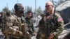 FILE - U.S. forces are seen at the Kurdish People's Protection Units (YPG) headquarters after it was hit by Turkish airstrikes in Mount Karachok near Malikiya, Syria, April 25, 2017. 