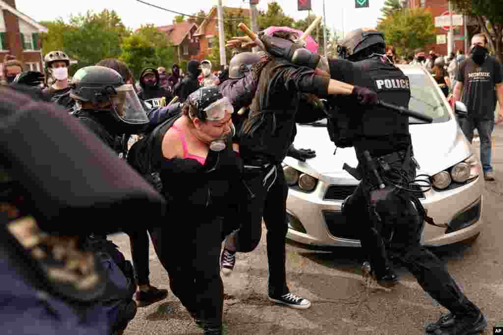 Police and protesters clash, Sept. 23, 2020, in Louisville, Kentucky after a grand jury indicted one officer on criminal charges six months after Breonna Taylor was fatally shot by police in Kentucky.