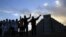 People gesture toward the the Kukulkan temple in Chichen Itza, Mexico, Dec. 21, 2012.