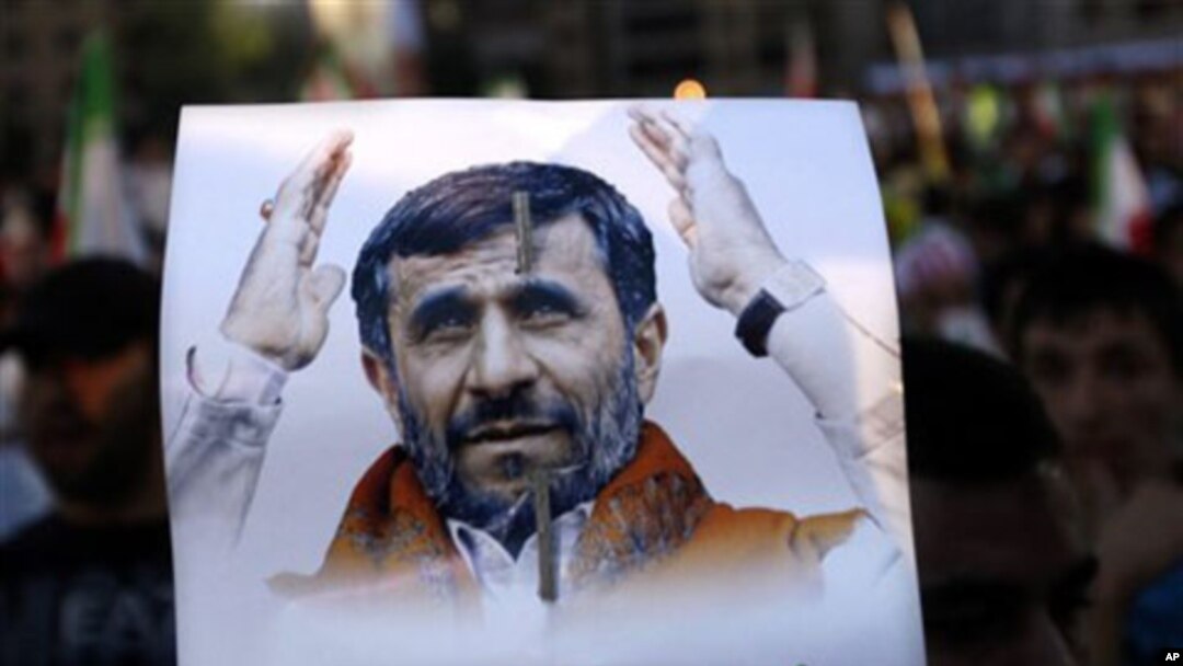 A Hezbollah supporter, holds a poster of Iranian President Mahmoud Ahmadinejad during a rally organized by Hezbollah for Ahmadinejad's visit to the southern suburb of Beirut, Lebanon, 13 Oct 2010