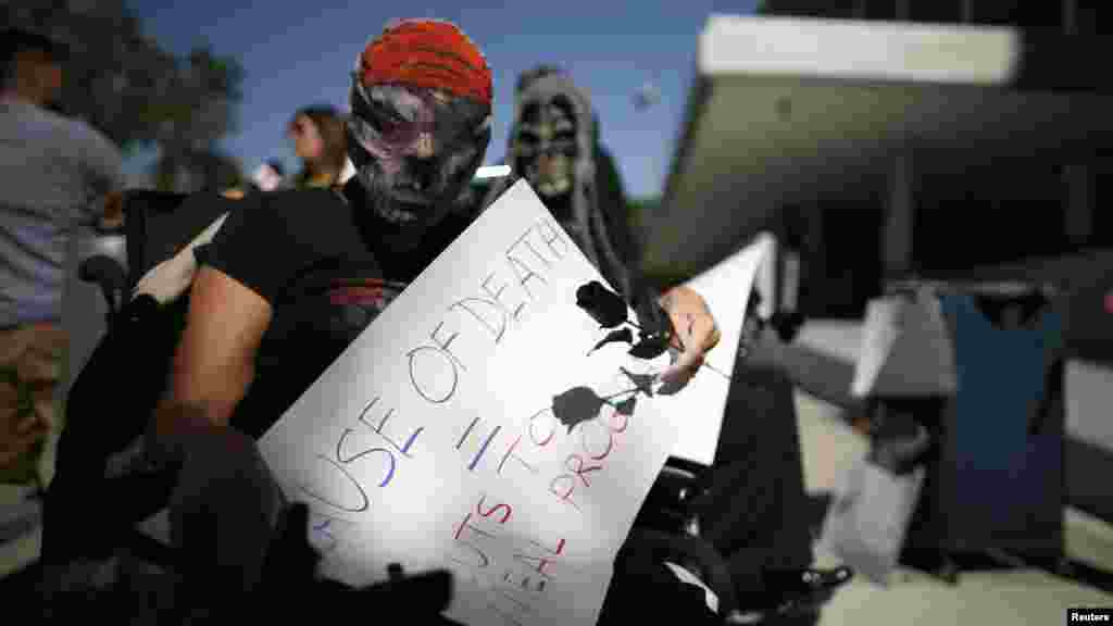 People protest against the government shutdown and potential cuts to Social Security and Medicare outside the Federal Building in Los Angeles.