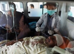 An injured man receives treatment inside an ambulance at a hospital after a blast in Kabul, Afghanistan, Aug. 7, 2019.