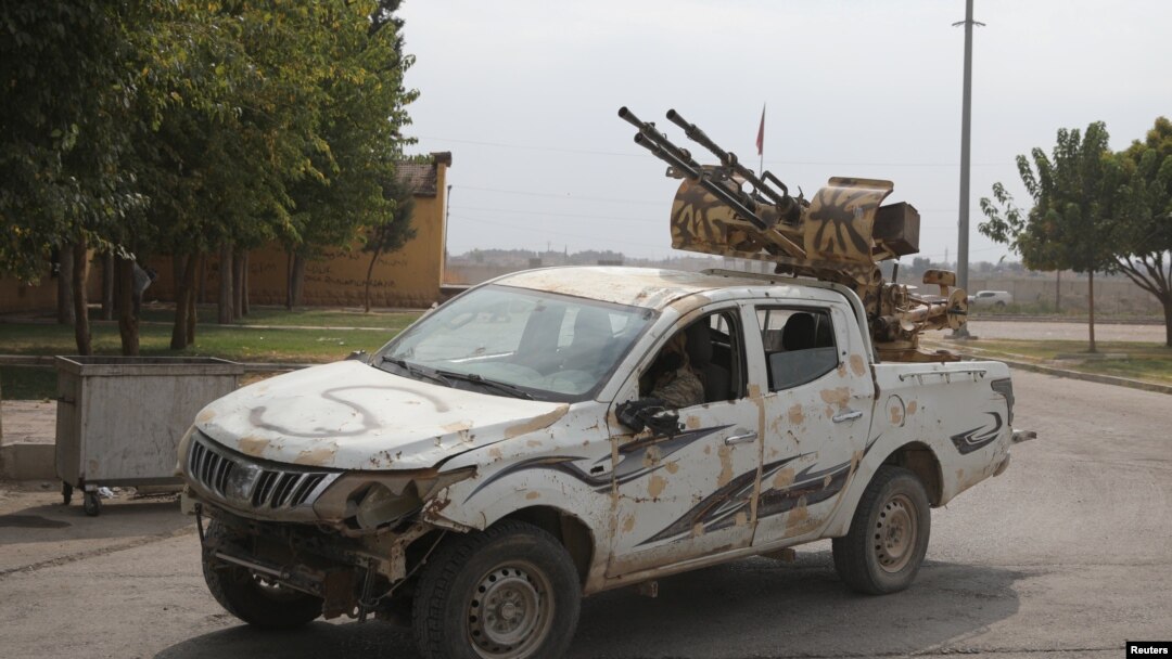 Turkey-backed Syrian rebel fighters return from the Syrian border town of Tal Abyad, see here on the Turkish-Syrian border in Akcakale, Turkey, Oct. 19, 2019. 