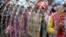 Cambodian garment workers shout slogans behind barbed wire set up by police near the Council of Ministers building during a rally in Phnom Penh, file photo. 