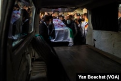 The body of activist Mazen al-Hamada is taken from the morgue in downtown Damascus, Syria, to last prayers before his funeral, Dec. 13, 2024.