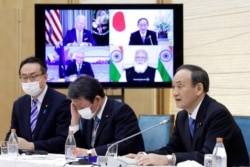 FILE - Japan's Prime Minister Yoshihide Suga speaks during the virtual summit of the leaders of Australia, India, Japan and the U.S., a group known as “the Quad", at his official residence in Tokyo, March 12, 2021.