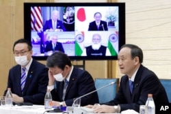 FILE - Japan's then-Prime Minister Yoshihide Suga speaks during the virtual summit of the leaders of Australia, India, Japan and the U.S., a group known as the Quad, at his official residence in Tokyo, Japan, March 12, 2021.