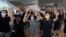 Protesters gesture with five fingers, signifying the "Five demands - not one less" outside a court during a protest in Hong Kong, Thursday, Aug. 27, 2020. Hong Kong police arrested 16 people, including two opposition lawmakers, on Wednesday on…