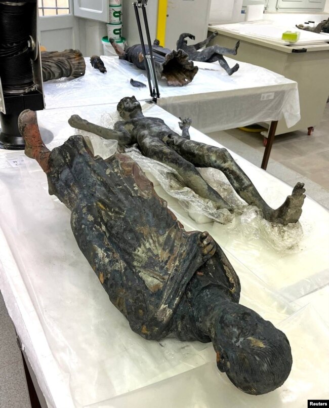 Newly discovered 2,300-year-old bronze statues are displayed at a laboratory in Grosseto, Italy, in this handout photo obtained by Reuters on November 8, 2022. (Ministero della Cultura/Handout via REUTERS)