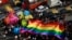 FILE - Participants holding a rainbow flag pass through a junction during a gay pride parade, which is promoting gay, lesbian, bisexual and transgender rights, in Mumbai, Jan. 31, 2015.