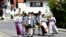 People in traditional clothes arrive to cast their vote for the European Parliament elections in Haunshofen near Starnberg, Germany, May 25, 2014. 