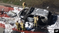 Emergency Situations Ministry rescuers examine a car of Tatarstan's chief mufti Ildus Faizov after a bomb attack in Kazan, about 700 kilometers (450 miles) east of Moscow, central Russia, July 19, 2012.