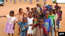 FILE - Children get ready to enter a class room in Yakouta, Burkina Faso. 