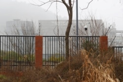 FILE - The P4 laboratory of Wuhan Institute of Virology is seen behind a fence during the visit by the World Health Organization (WHO) team tasked with investigating the origins of the coronavirus disease (COVID-19), in Wuhan, China, Feb. 3, 2021.