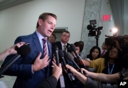FILE - Rep. Eric Swalwell, D-Calif., pauses to speak with reporters on Capitol Hill in Washington, July 16, 2018.