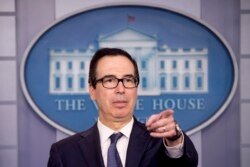 Treasury Secretary Steven Mnuchin takes a question from a reporter after announcing the threat of sanctions on Turkey in the Briefing Room of the White House in Washington, Oct. 11, 2019.