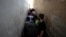 FILE - Syrians line up to buy bread at a shop in the town of Binnish in the country's northwestern Idlib province, June 9, 2020. 