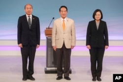 FILE - Taiwan's 2020 presidential election candidates, from right, Democratic Progressive Party's Tsai Ing-wen, People First Party's James Soong, and Nationalist Party's Han Kuo-yu attend a televised policy debate in Taipei, Taiwan, Dec. 29, 2019.