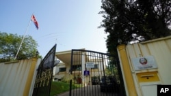 A North Korean flag flies by the entrance to the North Korean Embassy in Kuala Lumpur, Malaysia, Friday, March 19, 2021. North Korea on Friday said it was cutting diplomatic ties with Malaysia to protest a recent court ruling that allows a North…