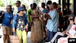 FILE - Traditional dancers perform to attract tourists at a shopping mall in downtown Suva, Fiji, on Dec. 15, 2022. Seven foreigners have been hospitalized after drinking cocktails at a five-star Fiji hotel resort, health officials said on Dec. 15, 2024.