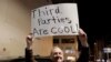 FILE - Libertarian Jeff Jared of Kirkland, Washington, holds a sign in support of third parties in Seattle, Jan. 31, 2019.