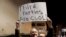 FILE - Libertarian Jeff Jared of Kirkland, Washington, holds a sign in support of third parties in Seattle, Jan. 31, 2019.