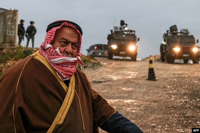 A Palestinian Muslim walks across an Israeli checkpoint in Qalandia in the occupied West Bank to attend the first Friday prayers of the fasting month of Ramadan at the Al-Aqsa Mosque compound in east Jerusalem on March 7, 2025.