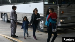 Migrant families seeking asylum are released from federal detention at a bus depot in McAllen, Texas, U.S., June 28, 2019. 