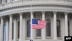 A U.S. flag is raised at the U.S. Capitol in Washington, Jan. 20, 2021.