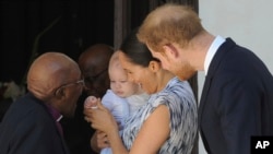 Britain's Prince Harry and Meghan, Duchess of Sussex, holding their son Archie, meets with Anglican Archbishop Emeritus, Desmond Tutu, in Cape Town, South Africa, Sept. 25, 2019.