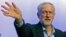 The new leader of Britain's opposition Labor Party, Jeremy Corbyn, waves as he acknowledges applause before addressing the Trade Union Congress in Brighton, England, Sept. 15, 2015.