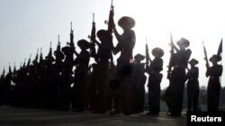 FILE - New recruits of Rajputana and Assam Rifles, units of the Indian army, swear their oaths of allegiance during a parade in New Delhi, June 1, 2002. 