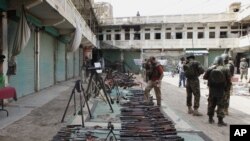 FILE - Pakistani soldiers display weapons reportedly captured from militants in Miran Shah in North Waziristan, July 9, 2014.