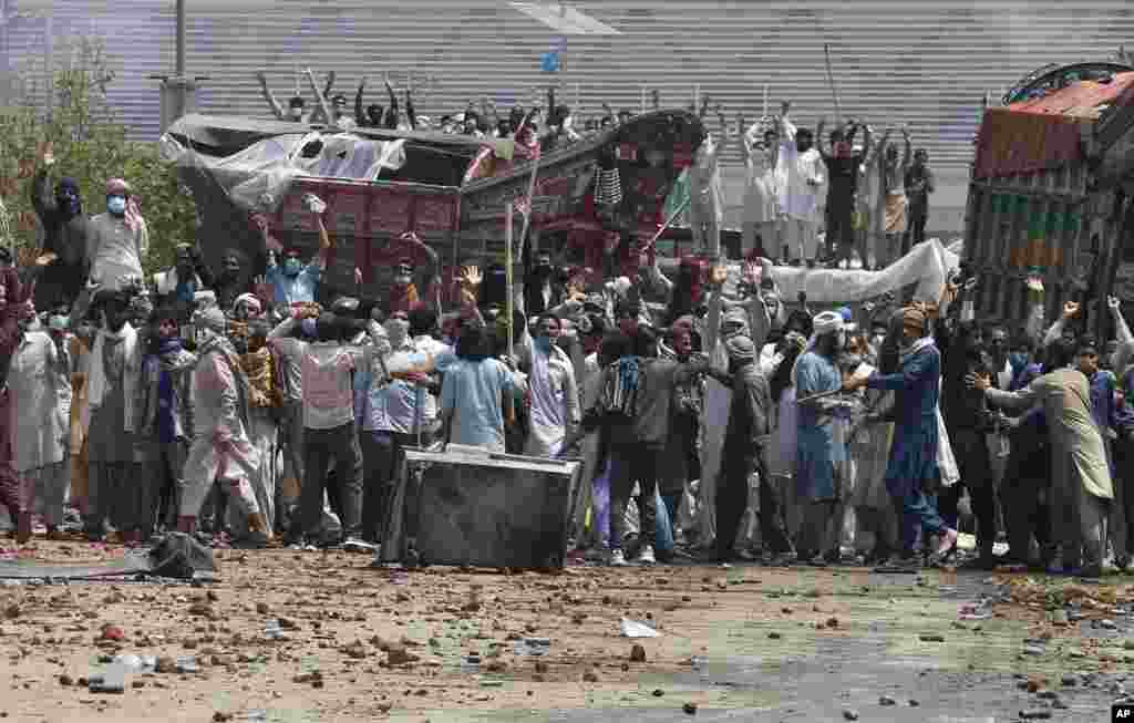 Supporters of Tehreek-e-Labiak Pakistan, a banned Islamist party, block a road and shout slogans protesting the arrest of their party leader Saad Rizvi, in Lahore, Pakistan.