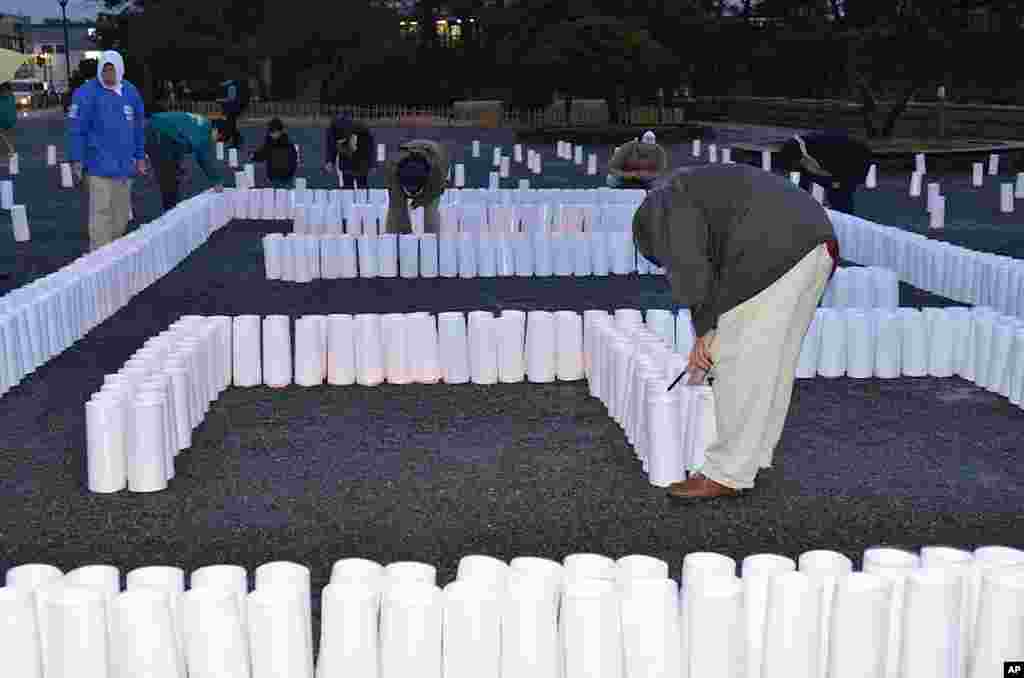 Lighting candles in Matsushima to remember those killed, March 9, 2012. (VOA - S. L. Herman)