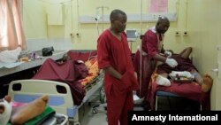 Paramedics treat a victim of Monday's explosion at Asokoro hospital in Abuja, Nigeria, April 15, 2014.