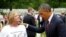 President Barack Obama speaks to a visitor at Arlington National Cemetery in Arlington, Virginia.