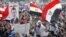 Supporters of Muslim brotherhood's presidential candidate Mohamed Morsi wave Egypt's national flag and posters of him in Tahrir Square in Cairo, June 19, 2012.