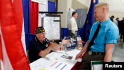 A U.S. veteran gets information at the Veterans Administration booth at the "Hire Our Heroes" Job fair in Sandy, Utah, March 25, 2014.