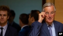 European Union chief Brexit negotiator Michel Barnier, right, arrives for a meeting of EU General Affairs ministers, Article 50, at the European Convention Center in Luxembourg, Tuesday, Oct. 15, 2019.