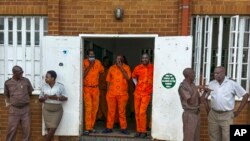 FILE - Inmates at the all-male Zonderwater Correctional Centre on the outskirts of Pretoria, South Africa, wait Feb. 1, 2024, to register as voters or update their details on electoral rolls.